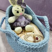 Милейшая вязаная люлька для куклы , мягкой игрушки— идеальный аксессуар для детских игр. Изделие выполнено вручную из хб шнура нежно-голубого цвета, что придаёт ему особую уютность и привлекательность. Особенности: Люлька:связана крючком, имеет прочную и аккуратную вязку; оснащена удобными боковыми ручками для переноски; форма люльки эргономична, идеально подходит для размещения куклы или игрушки; внутри находится матрас,подушка,одеяло из бязи (детский принт), создающим дополнительный уют. Преимущества: ручная работа — уникальность и качество исполнения; гипоаллергенные материалы, безопасные для ребёнка; компактный размер, удобный для игр и хранения; эстетичный дизайн, который понравится как детям, так и взрослым. Назначение: для сюжетных игр с куклами и мягкими игрушками; как декоративный элемент в детской комнате; в качестве подарка для маленькой принцессы. Рекомендации по уходу: ручная стирка в тёплой воде (до 30°C); сушка в расправленном виде вдали от прямых солнечных лучей. Этот комплект подарит ребёнку массу положительных эмоций и станет любимым элементом игровой зоны. Этот очаровательный набор ручной работы идеально подойдёт для сюжетных игр с куклами и игрушками. В комплект входят: Вязаная люлька из хб шнура нежно-голубого цвета. Постельные принадлежности из ткани бязь с детским принтом. Подарите ребёнку немного волшебства с этим милым набором!