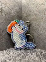 Представляем очаровательный брелок, выполненный в технике вышивки крестиком на пластиковой канве. Центральным элементом дизайна стал милый котик, который держит в лапках ярко-оранжевую морковку с зелёной ботвой. Этот аксессуар сочетает в себе игривость и утончённость, станет стильным дополнением к ключам, рюкзаку или сумке