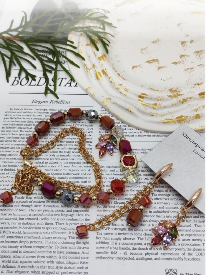 Комплект украшений: браслет и серьги «Яркая элегантность» Позвольте себе окунуться в мир утончённой роскоши с этим изысканным комплектом — браслетом и серьгами, которые станут настоящей изюминкой вашего образа. Сочетание золотистых цепочек и многогранных бусин создаёт эффектный, но гармоничный акцент, который подойдёт как для повседневной носки, так и для особых случаев.