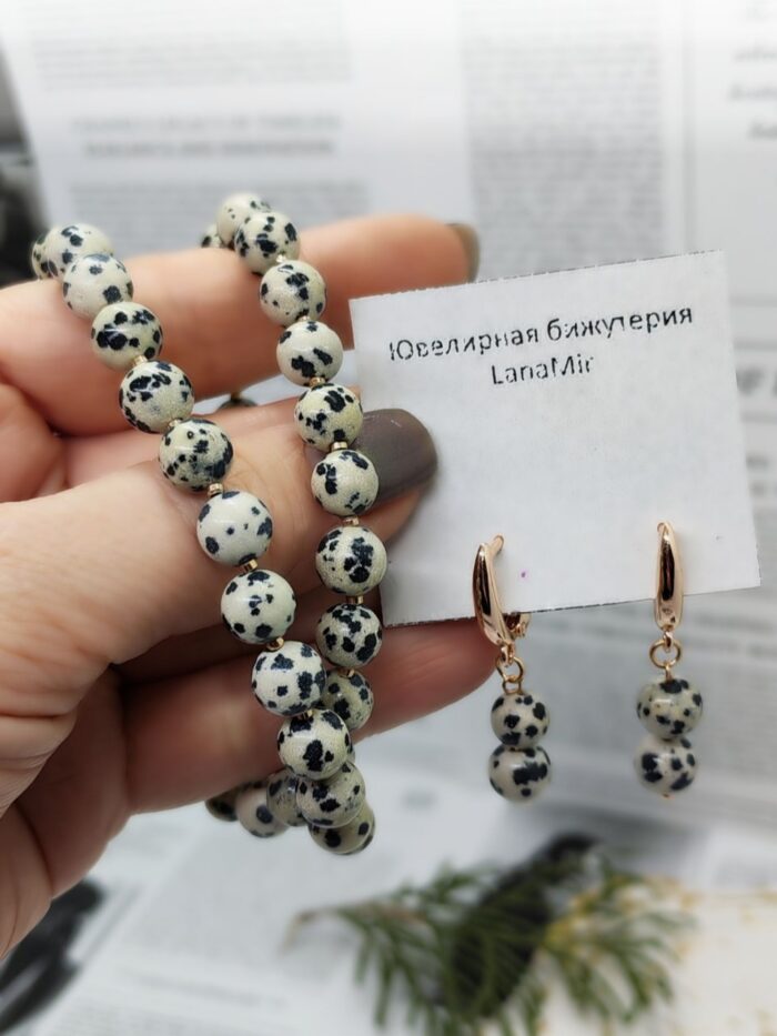 Комплект Далматиновая яшма Откройте для себя магию природных оттенков с изысканным комплектом бижутерии от LanaMir — колье и серьги с натуральной далматиновой яшмой. Этот аксессуар станет настоящей изюминкой вашего образа, сочетая в себе природную эстетику и утончённую простоту.