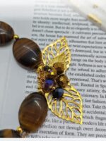 Браслет Тигровый акцент Браслет с тигровым глазом и золотыми элементами: гармония силы и изящества. Откройте для себя магию природных камней с этим изысканным браслетом, сочетающим в себе мощь тигрового глаза и утончённость золотых деталей. Украшение станет не только стильным аксессуаром, но и вашим личным талисманом.