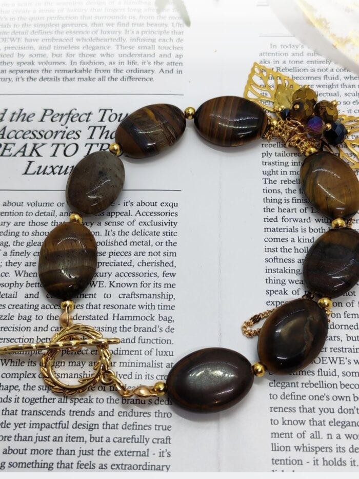 Браслет Тигровый акцент Браслет с тигровым глазом и золотыми элементами: гармония силы и изящества. Откройте для себя магию природных камней с этим изысканным браслетом, сочетающим в себе мощь тигрового глаза и утончённость золотых деталей. Украшение станет не только стильным аксессуаром, но и вашим личным талисманом.