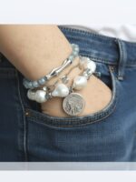 Браслет с жемчугом Майорка и сахарным кварцем: воплощение элегантности и индивидуальности Ищете украшение, которое подчеркнёт вашу утончённость и добавит нотку роскоши в любой образ? Представляем вам эксклюзивный браслет, сочетающий в себе изысканность жемчуга, нежность кварца и изящество серебряных элементов. Почему этот браслет заслуживает вашего внимания? · Роскошный дизайн. Крупные жемчужные бусины неправильной формы создают ощущение природной гармонии и уникальности. Нежно-голубой кварц напоминает о морском бризе и добавляет свежести образу. · Сочетание материалов. Серебряные элементы разной формы (гладкие, фактурные, изогнутые) создают интересную игру линий и текстур, делая браслет по-настоящему уникальным. · Особая деталь — монета-подвеска. Центральный элемент украшения — стилизованная монета с рельефным изображением. Она придаёт браслету винтажный шарм и делает его настоящим акцентом в образе. · Универсальность. Этот браслет легко сочетается как с повседневной одеждой, так и с вечерними нарядами. Он подойдёт для офиса, романтического ужина или торжественного мероприятия. · Три в одном. Этот аксессуар можно разделить на три самостоятельных браслета. Можно носить все сразу или по оному... Все, как пожелает ваше настроение · Качество исполнения. Каждый элемент тщательно подобран и надёжно закреплён. Браслет удобен в носке и не теряет внешний вид со временем. Идеальный подарок! Ищете подарок для особенной женщины? Этот браслет станет символом вашей заботы и внимания. Он подойдёт как для молодой девушки, так и для зрелой дамы, ценящей классику и элегантность. Не упустите возможность пополнить свою коллекцию украшений настоящим произведением искусства! Добавьте этот браслет в корзину уже сегодня и позвольте себе наслаждаться его красотой каждый день. Для заказа и по всем вопросам обращайтесь Телефон: +79817339605 WhatsApp: wa.me/79817339605 Группа в Telegram: t.me/LanaMir03 Сообщения группы VK: vk.me/lanamirc Группа VK, где вы найдете еще больше украшений: https://vk.com/lanamirc Или можно оформить заказ и задать вопрос прямо здесь, на нашем маркетплейсе https://marketcraft.ru/store/lanamir/ Нас находят по запросам: Браслет ручной работы, жемчуг, кварц, сахарный кварц, серебро, бусины, подвеска-монета, винтажный стиль, элегантность, украшение, женский аксессуар, ручная работа, изысканность, перламутр, голубые бусины, декоративные элементы, стильный браслет, ювелирное изделие, аксессуар для образа, дизайнерский браслет, браслет с камнями, тройной браслет